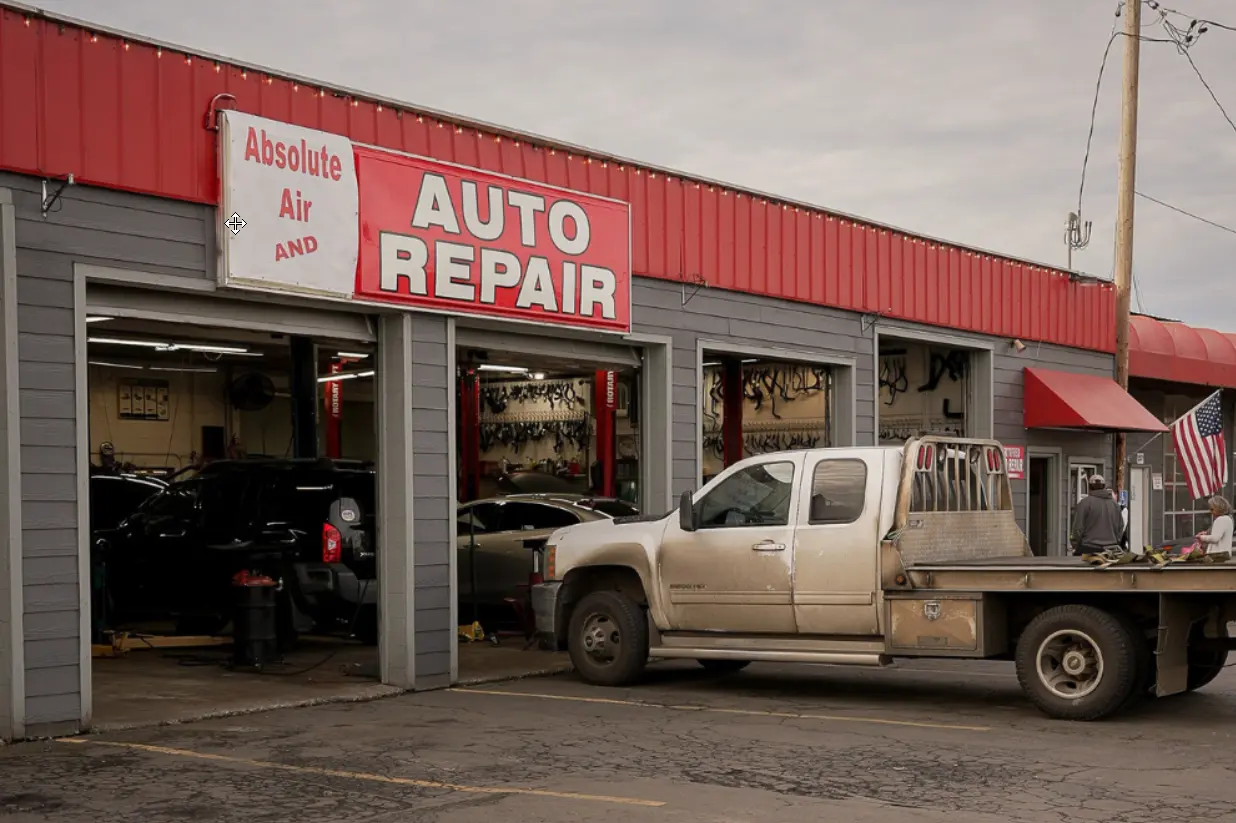 National Car Care Month, auto repair in Springfield, OR, at Absolute Air & Auto Repair. Image of busy auto repair shop exterior with open service bays and vehicles, highlighting professional service and reliable vehicle care.