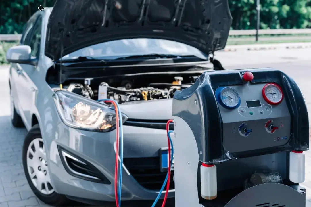 Auto repair in Springfield, OR, at Absolute Air & Auto Repair. Image of a vehicle connected to professional air conditioning service equipment during refrigerant recovery and recharge, helping restore cold airflow, improve cooling performance, and ensure reliable summer driving comfort.
