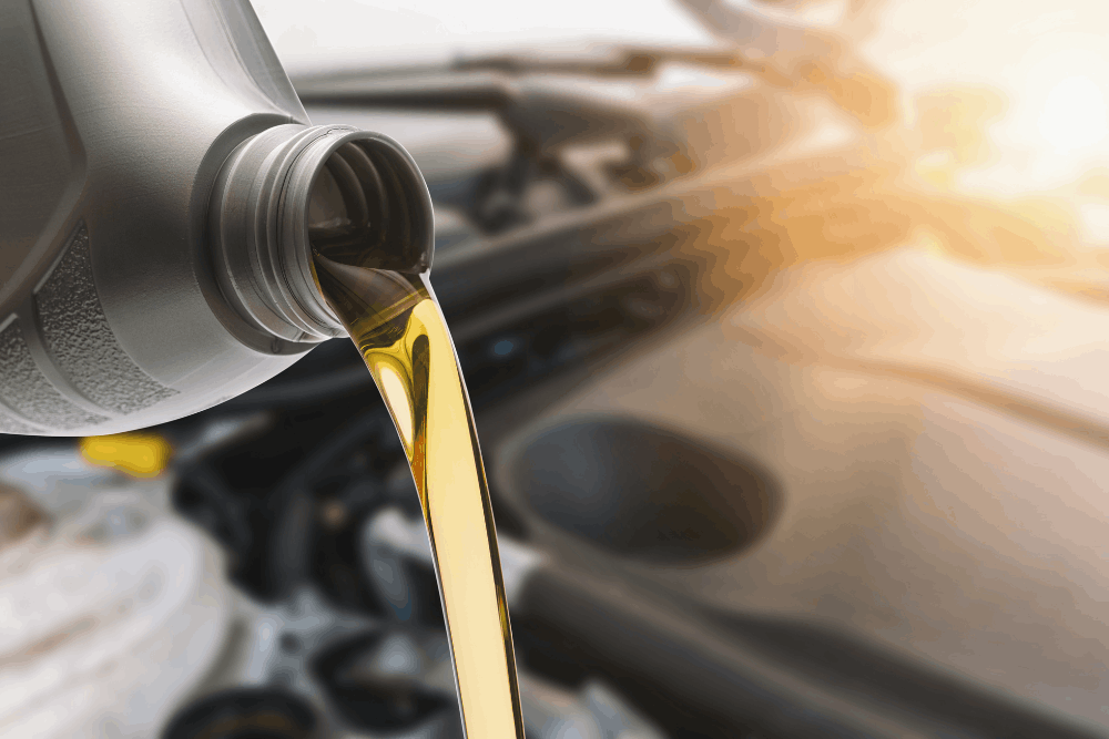 Oil change, auto repair in Springfield, OR, at Absolute Air & Auto Repair. Image of fresh engine oil being poured into a vehicle during an oil change service, highlighting preventative maintenance that protects engine performance, improves reliability, and extends engine life.